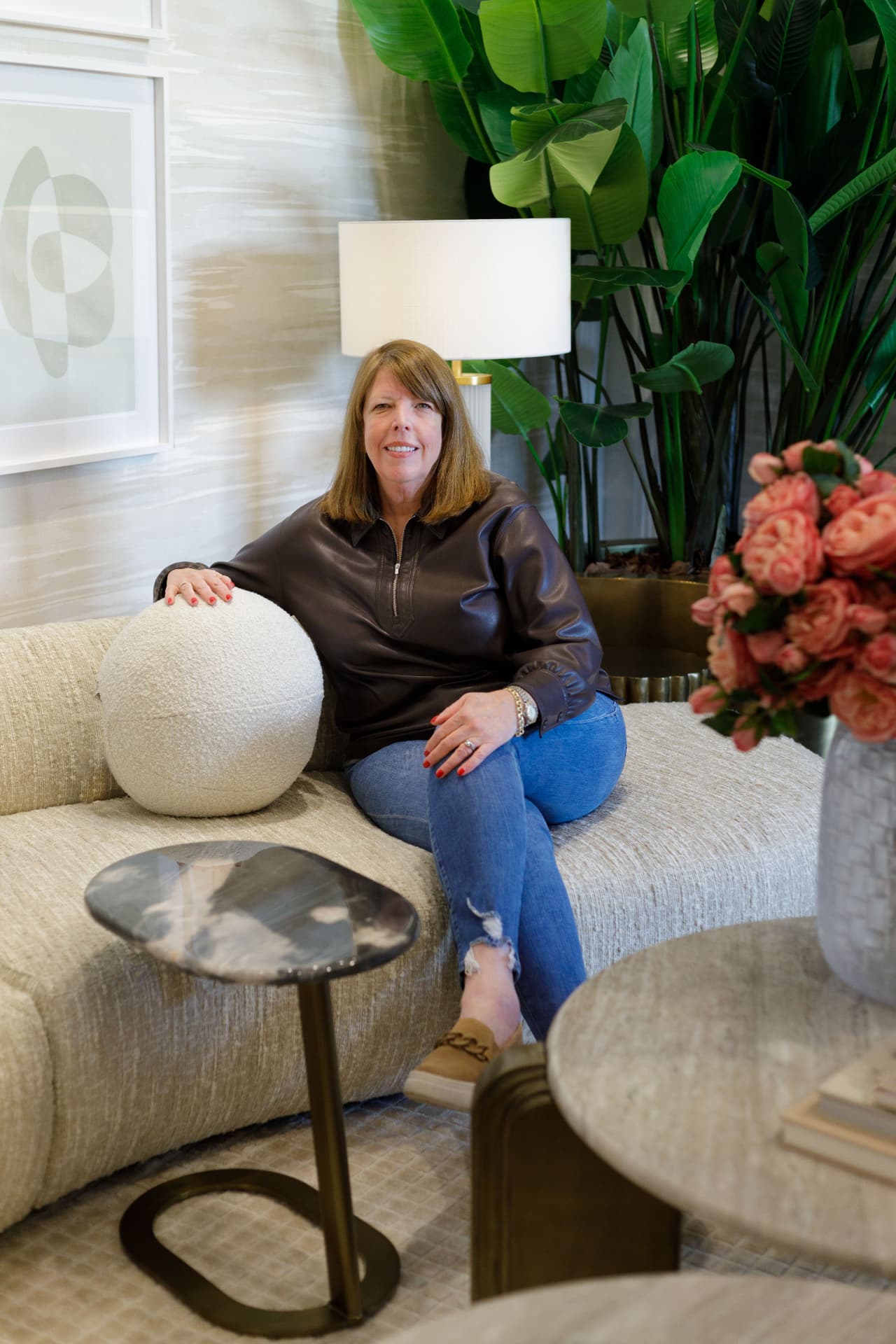 Shelley Davenport, founder of The Open Door Style & Design, seated in a styled living room
